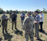 Congressman Tom Barrett talks with Secretary of the Army Daniel Driscoll, Maj. Gen. Paul Rogers, Congressman Jack Bergman, and troops during Exercise Northern Strike at Camp Grayling on Friday, August 8, 2025.
